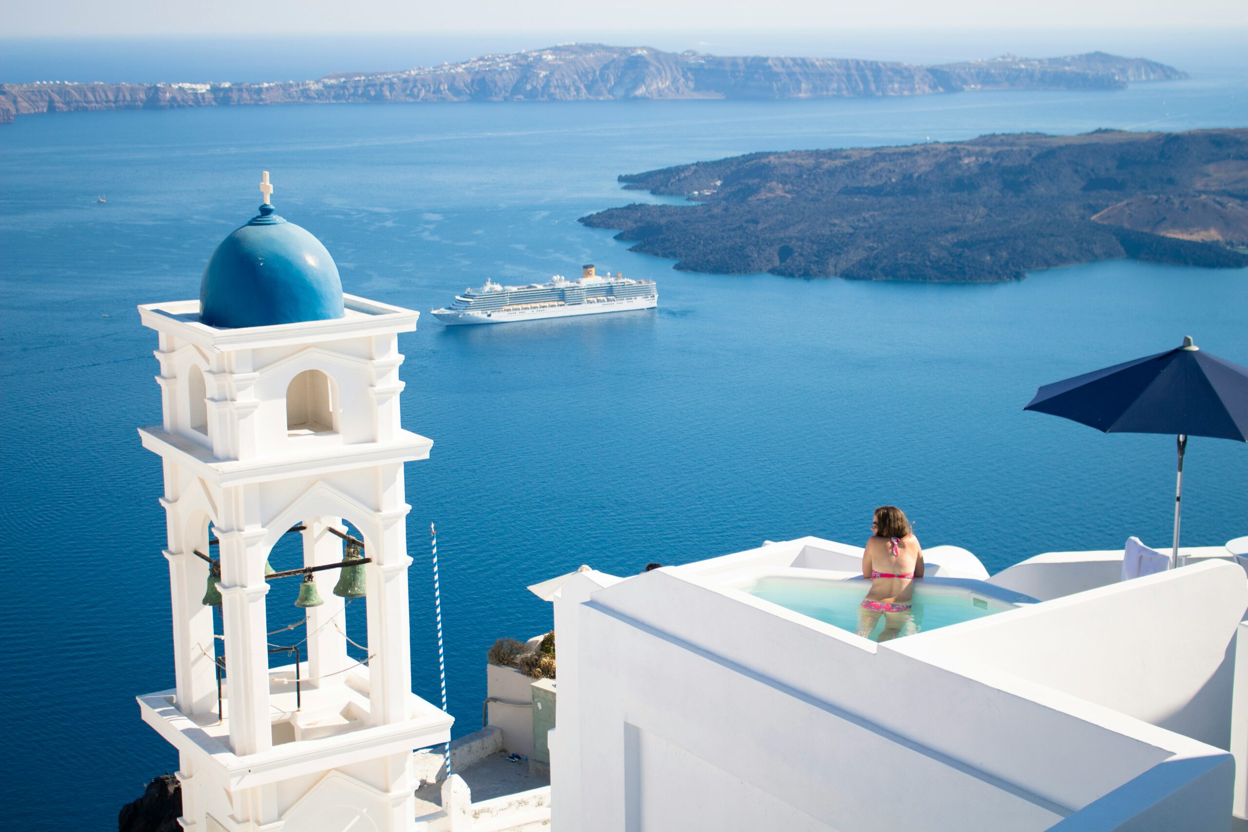 Women in private pool overlooking sea in Santorini, Greece